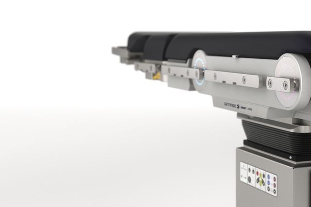 Surgical table with a sleek design and visible control panel, set against a white background.
