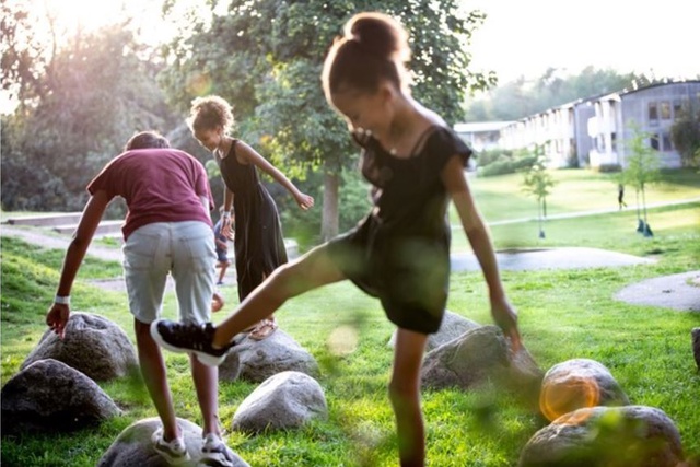 Three children playing in a park