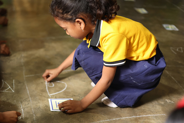 Child playing on the floor - courtesy of Pratham