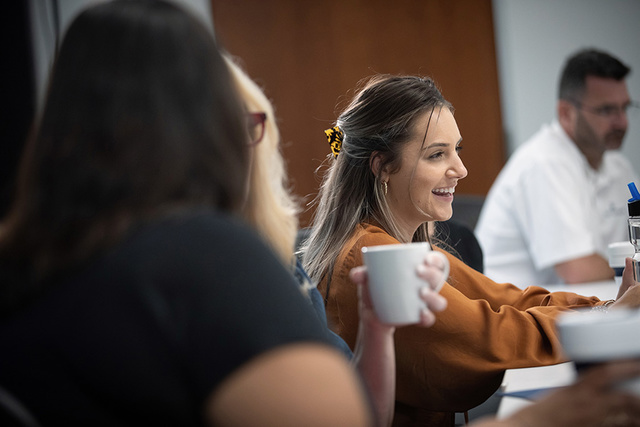 woman smiling druing a team meeting
