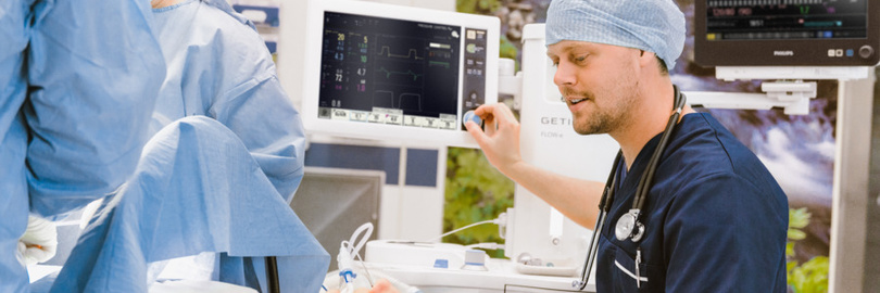 Anesthesiologist monitoring a patient in the operating room
