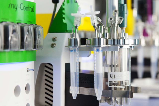 Laboratory equipment with test tubes connected to various probes and sensors, used for scientific experiments.