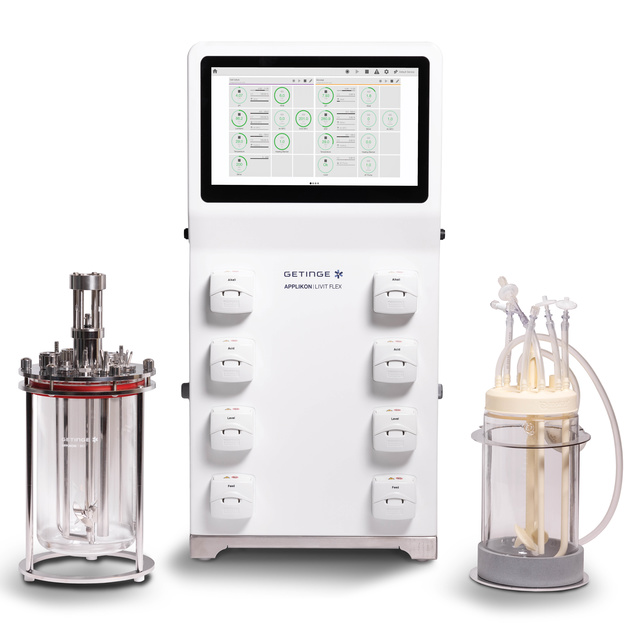 Laboratory bioreactor system with a main control unit, left stainless steel vessel, and right glass vessel with tubes.