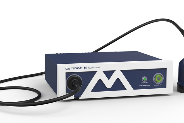 Medical device with a control unit and handheld probe, labeled ww5 Fluxerm. Connected by a black cable.