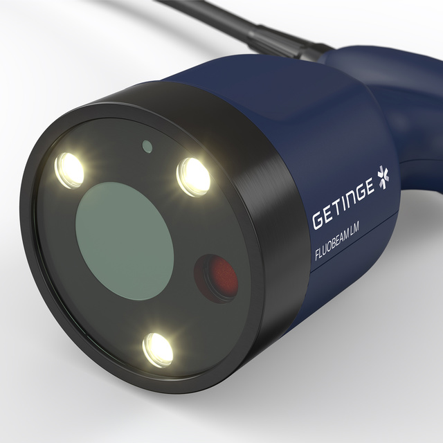 Blue and black handheld medical device with three glowing white lights and labeled ww5 Fluobeam LM.