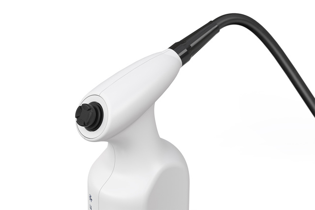 Close-up of a white handheld electronic device with a black cable, featuring a pointed nozzle.