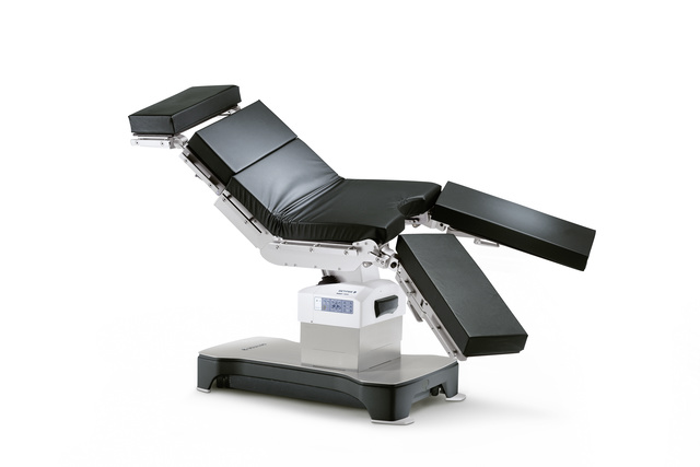 Adjustable black medical examination chair with multiple movable sections on a sturdy base.