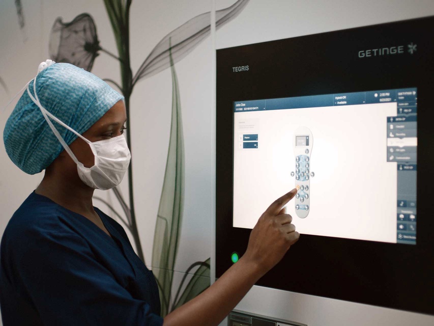 OR nurse using Tegris OR integration solution from ww5 to set up the operating table in the operating room