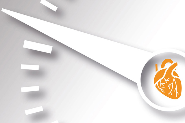 A white gauge needle points to an orange heart illustration, symbolizing heart health or cardiovascular monitoring.